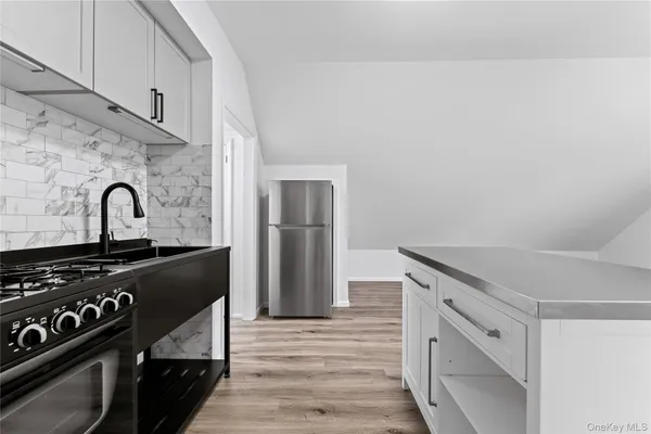 a kitchen with a stove and a refrigerator