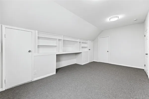 a view of an empty room with cabinet