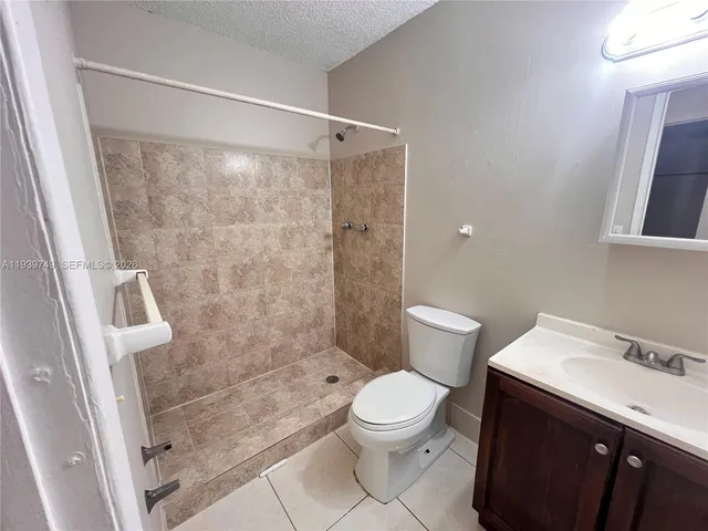 a bathroom with a shower toilet and sink