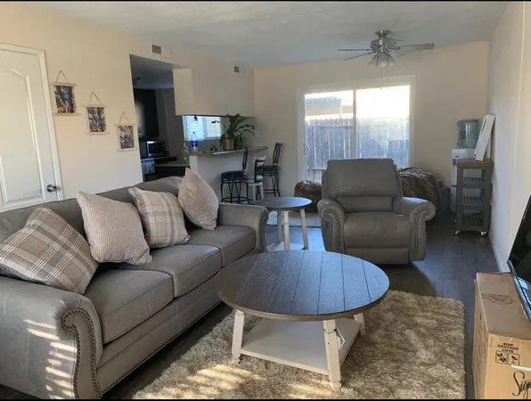 a living room with furniture a lamp and a chandelier