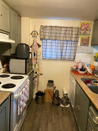 a kitchen with a sink stove and cabinets