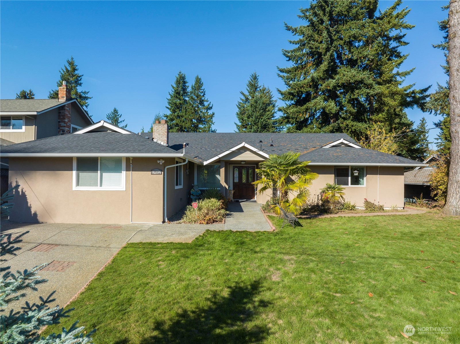 Undisclosed Address Bellevue, WA 98008 - Photo 2 of 28 a front view of a house with a yard and garage