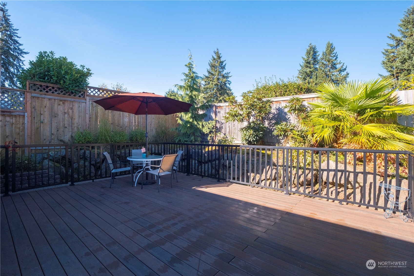 Undisclosed Address Bellevue, WA 98008 - Photo 27 of 28 a view of a deck with furniture and a yard