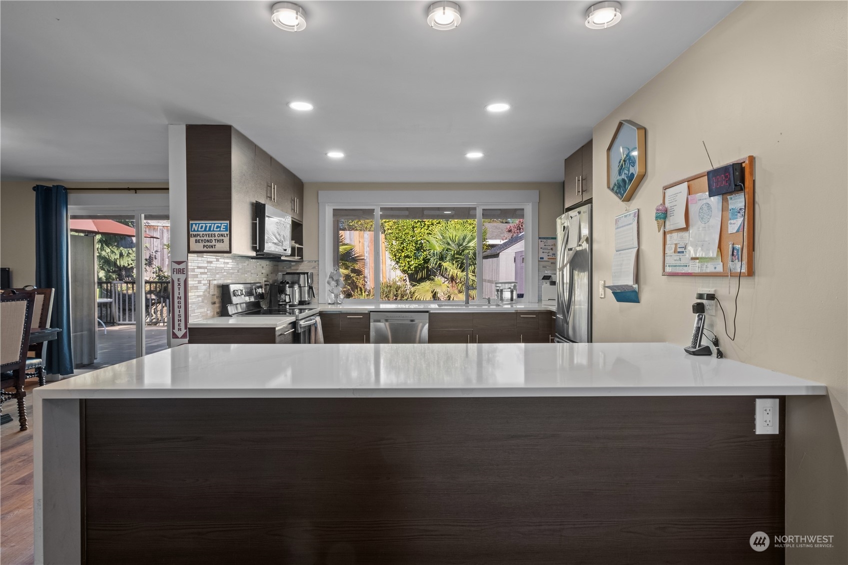 Undisclosed Address Bellevue, WA 98008 - Photo 6 of 28 a large white kitchen with kitchen island granite countertop a large counter top stainless steel appliances and a large window