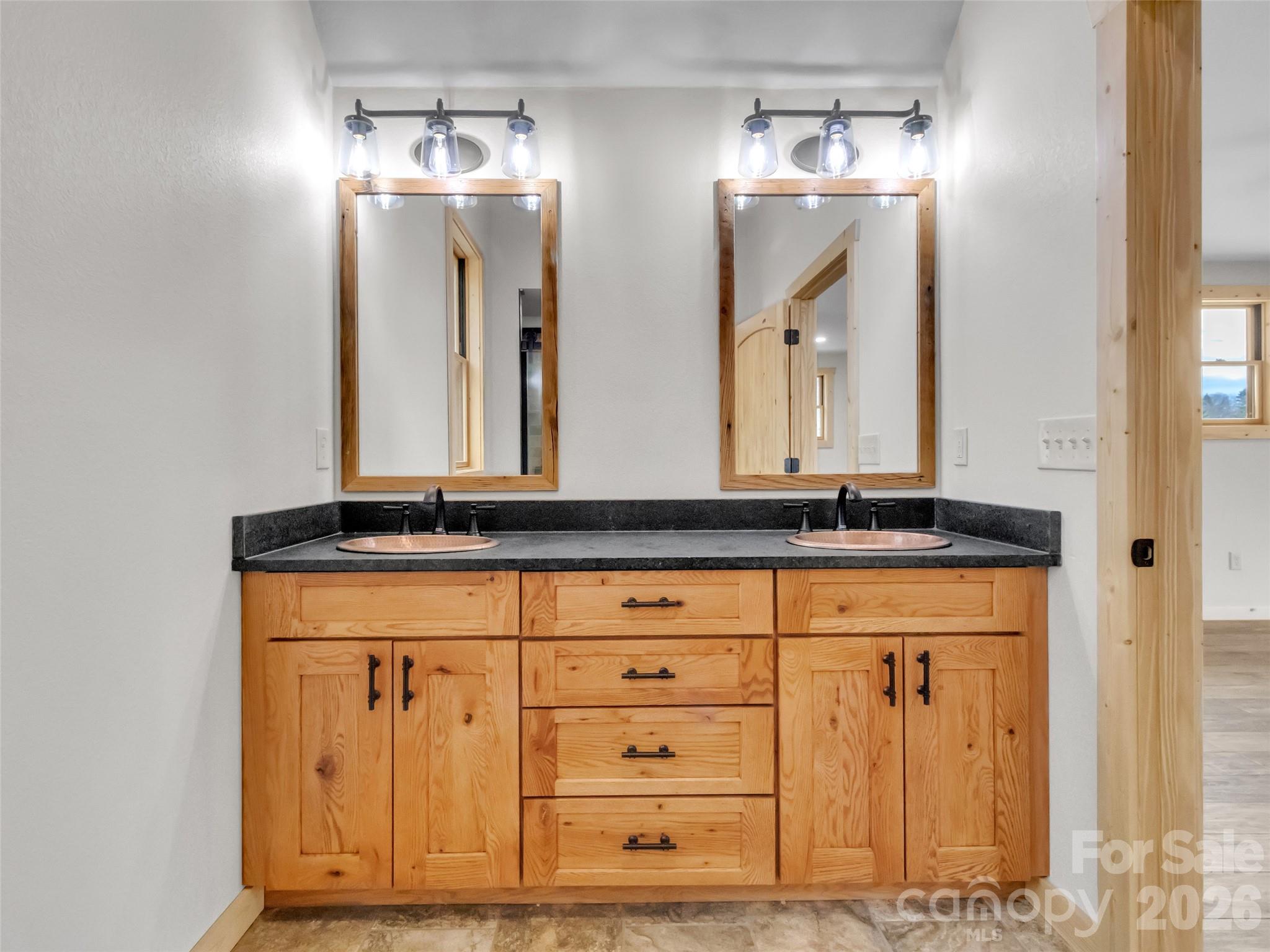 171 Cowtail Cove Clyde, NC 28721 - Photo 30 of 48 a bathroom with a sink vanity and a mirror