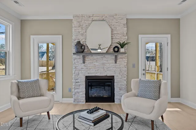 a living room with furniture chandelier and a fireplace
