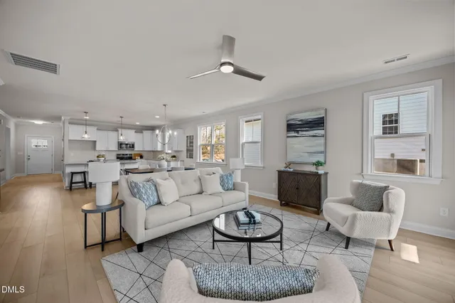 a bedroom with a bed a dresser and painting on the wall
