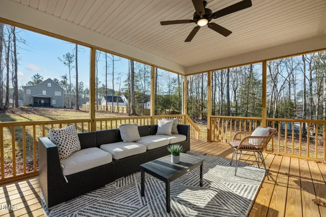 a view of a house with backyard and porch
