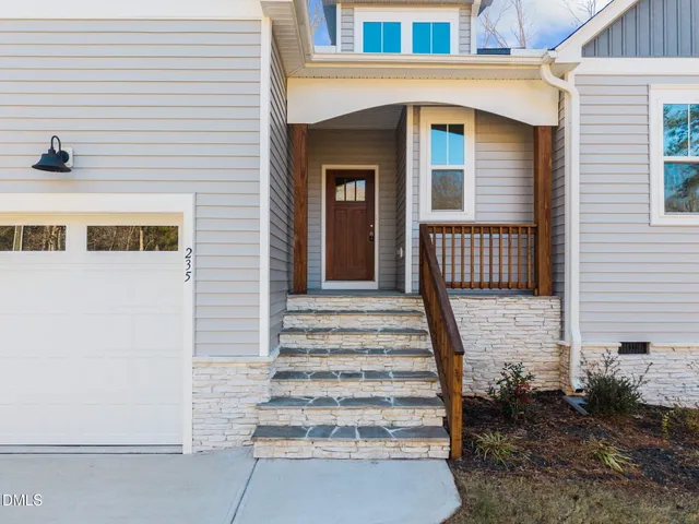 a kitchen with a center island white cabinets and stainless steel appliances