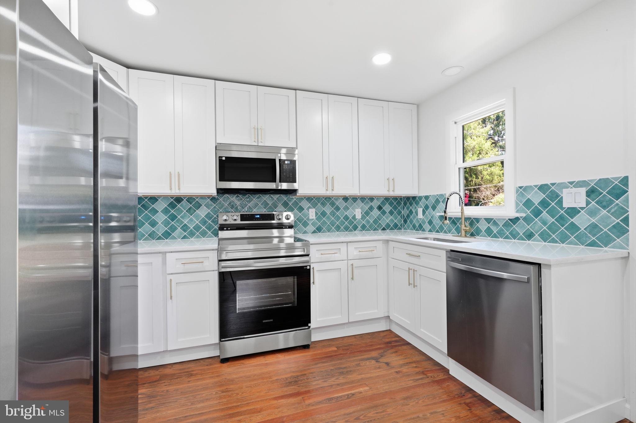 124 Cedar Road Riegelsville, PA 18077 - Photo 12 of 50 Modern kitchen with vibrant tiles.