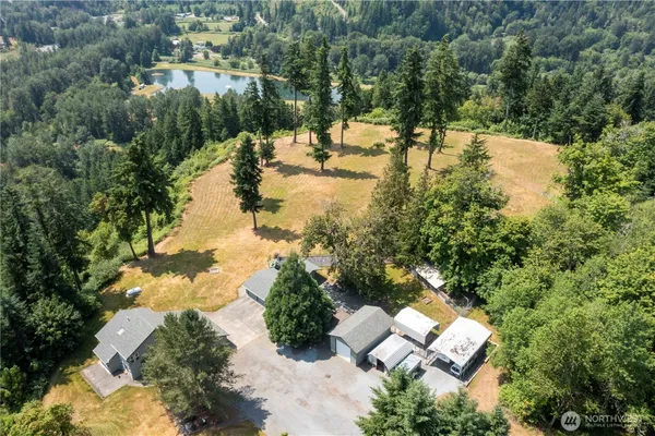 an aerial view of residential house with outdoor space and lake view