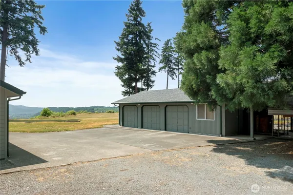 a view of a house with a outdoor space and trees