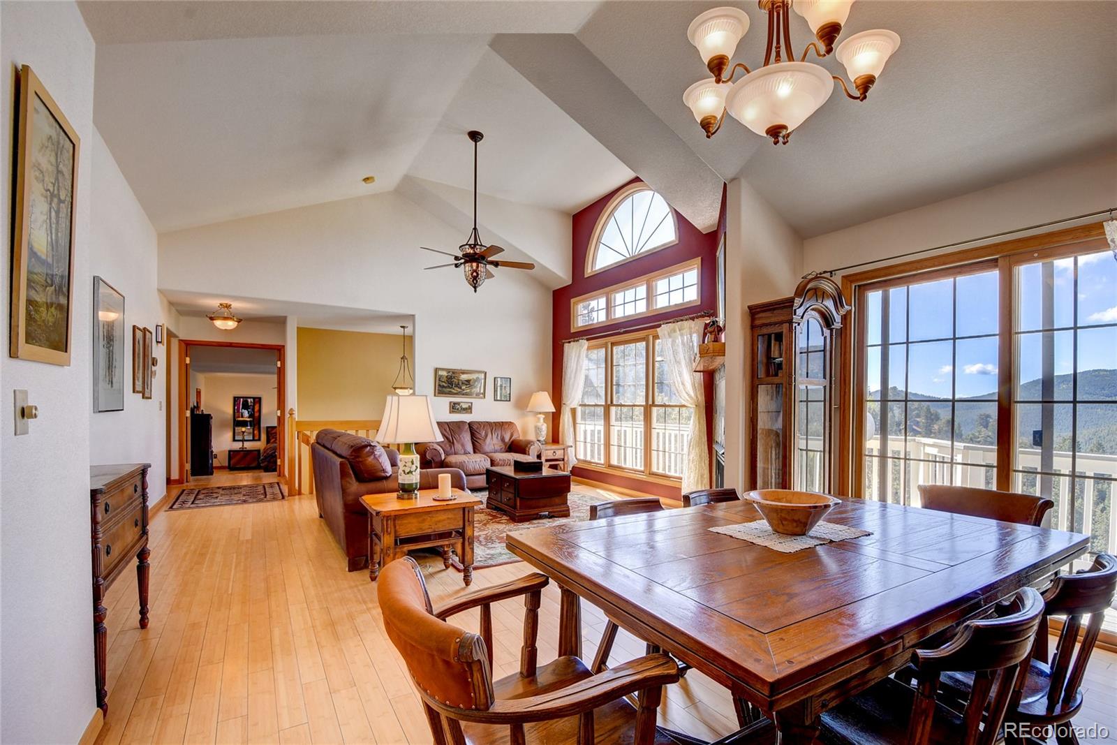 33633 Elk Run Evergreen, CO 80439 - Photo 12 of 40 a view of a dining room with furniture window and wooden floor