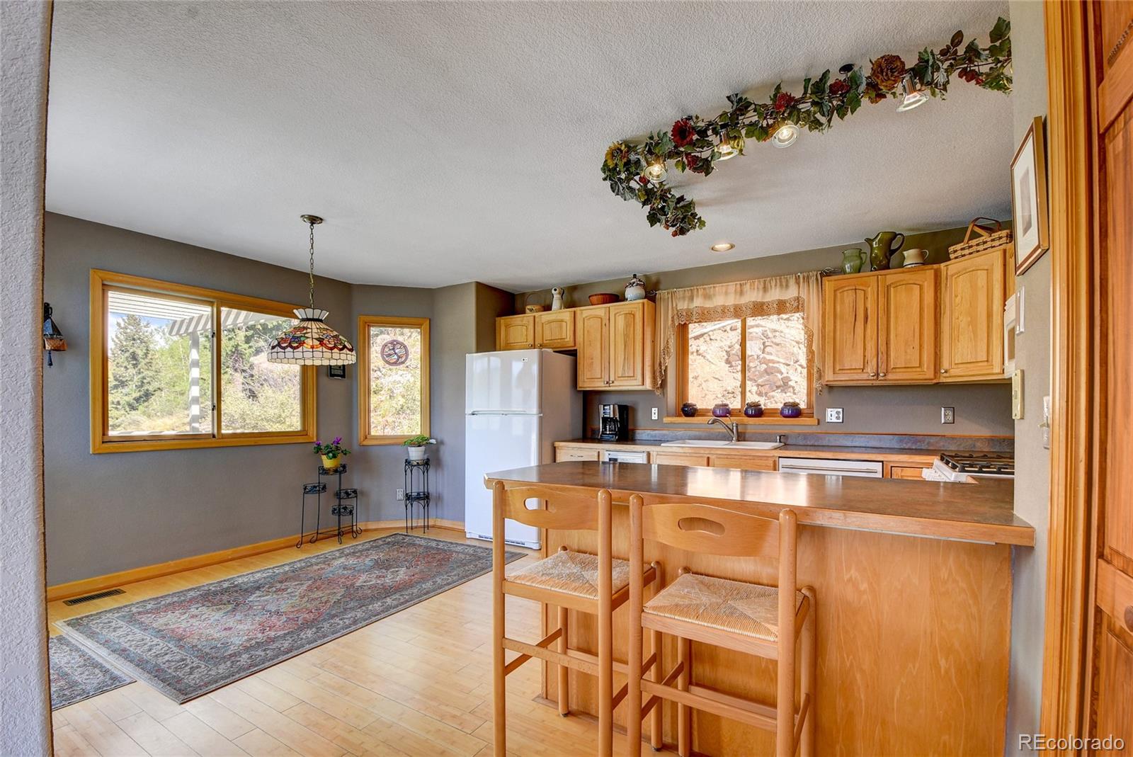33633 Elk Run Evergreen, CO 80439 - Photo 15 of 40 a large kitchen with a table and chairs