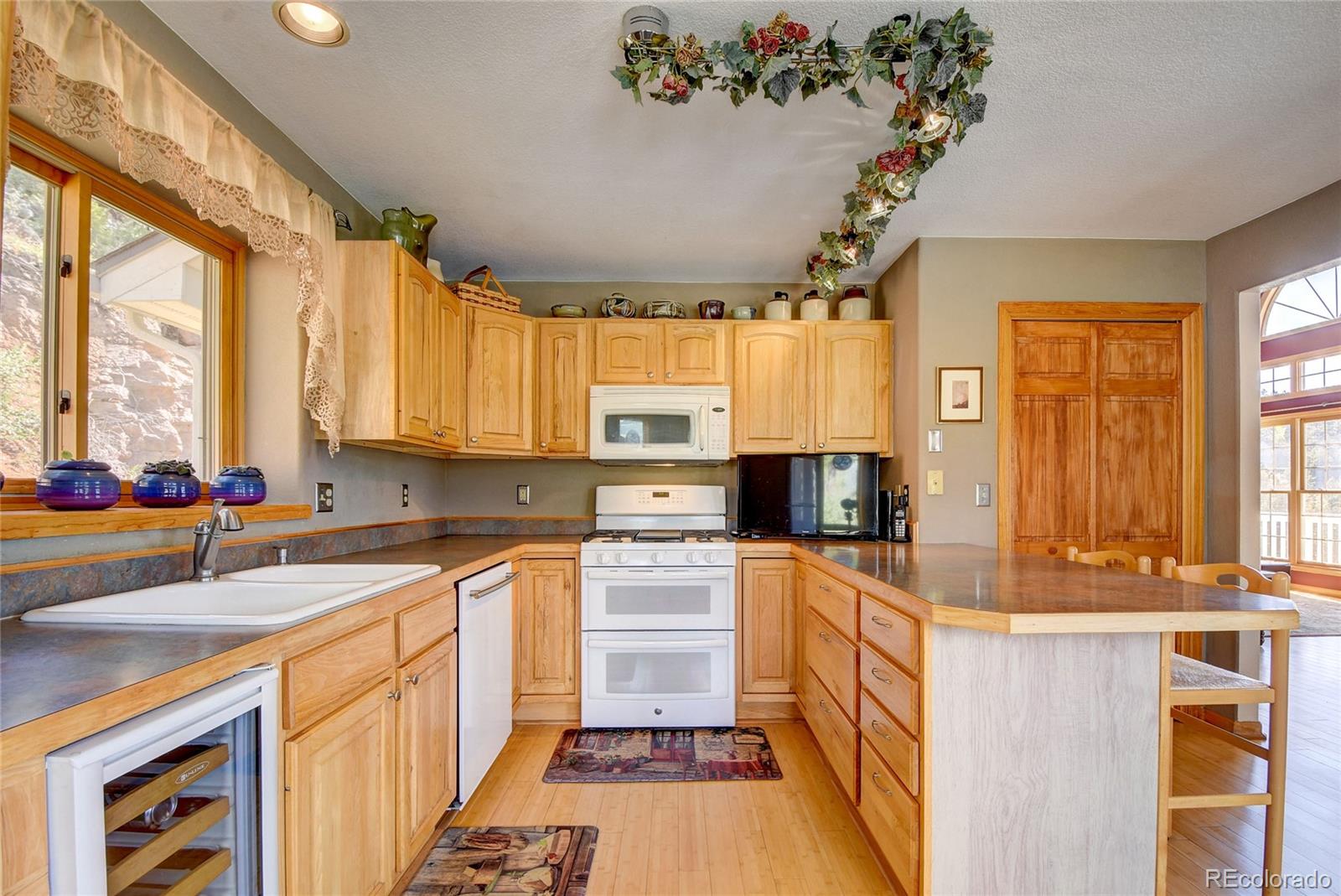 33633 Elk Run Evergreen, CO 80439 - Photo 17 of 40 a kitchen with a large window appliances and cabinets