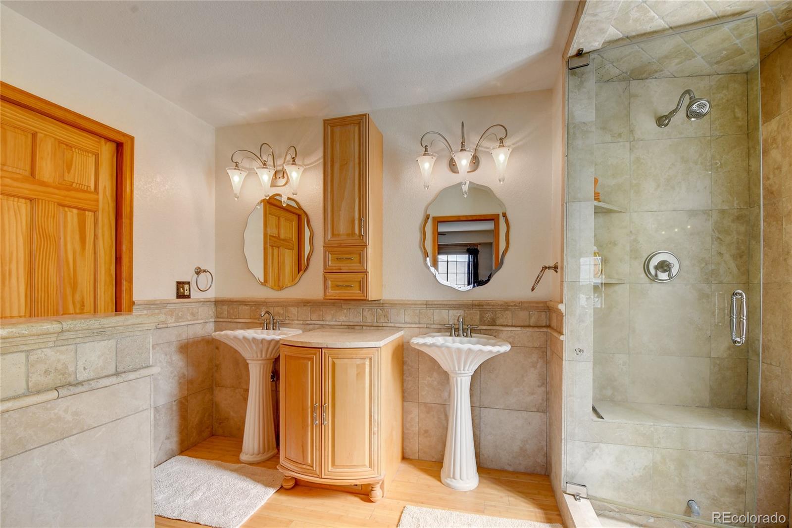 33633 Elk Run Evergreen, CO 80439 - Photo 20 of 40 a bathroom with a double vanity sink mirror and bathtub