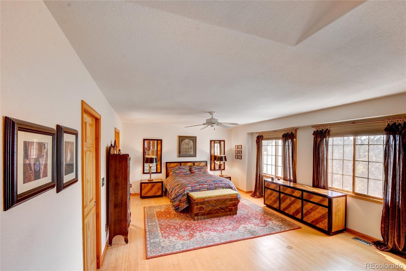 33633 Elk Run Evergreen, CO 80439 - Photo 24 of 40 a bedroom with furniture and large windows