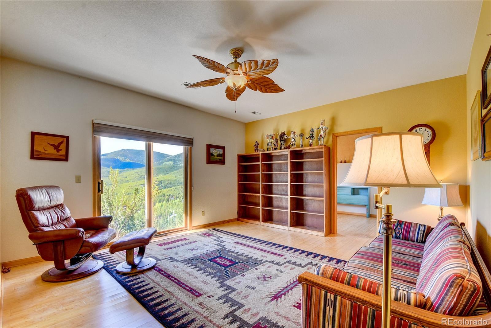 33633 Elk Run Evergreen, CO 80439 - Photo 30 of 40 a bedroom with a bed and a chandelier