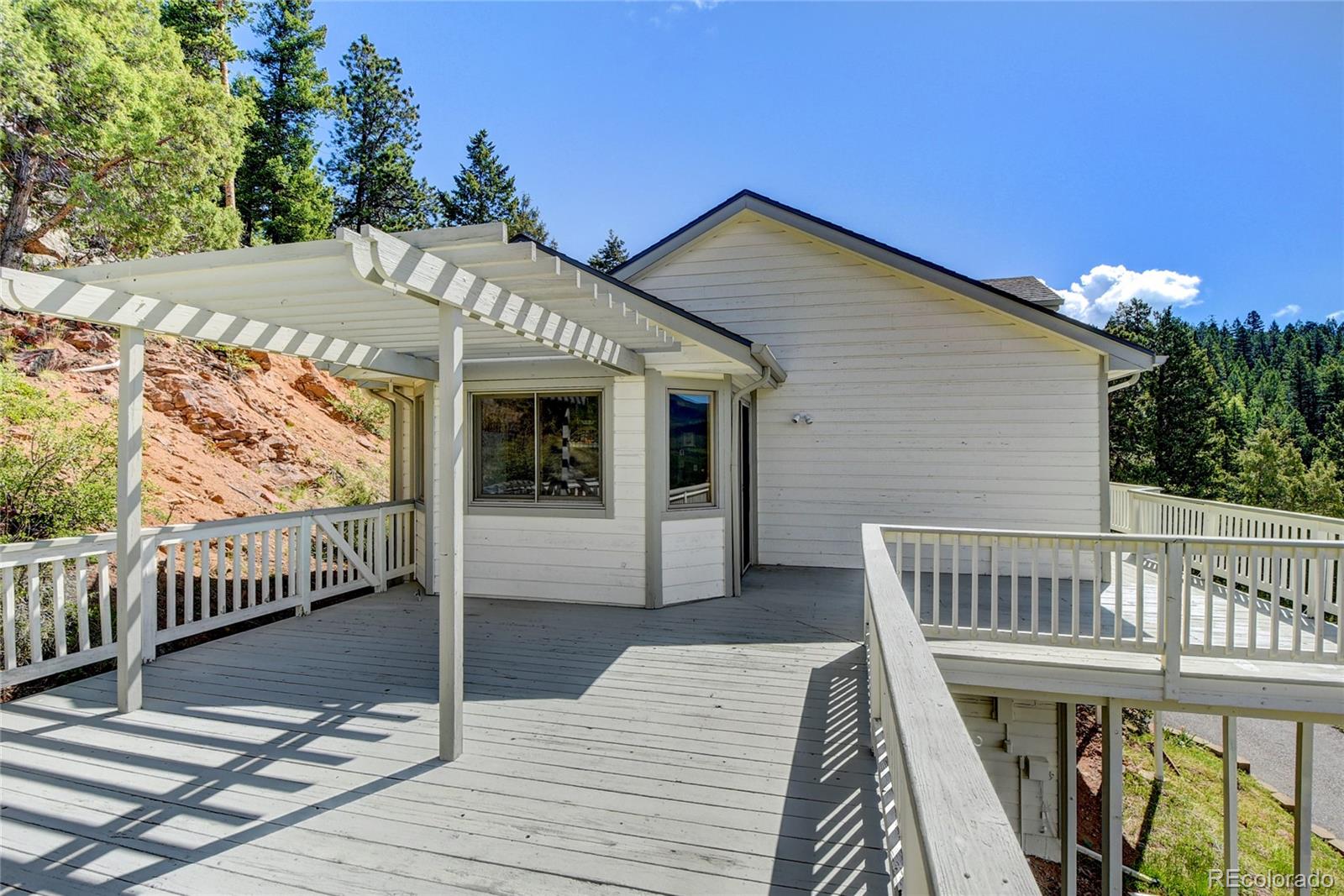 33633 Elk Run Evergreen, CO 80439 - Photo 32 of 40 a view of a house with a deck