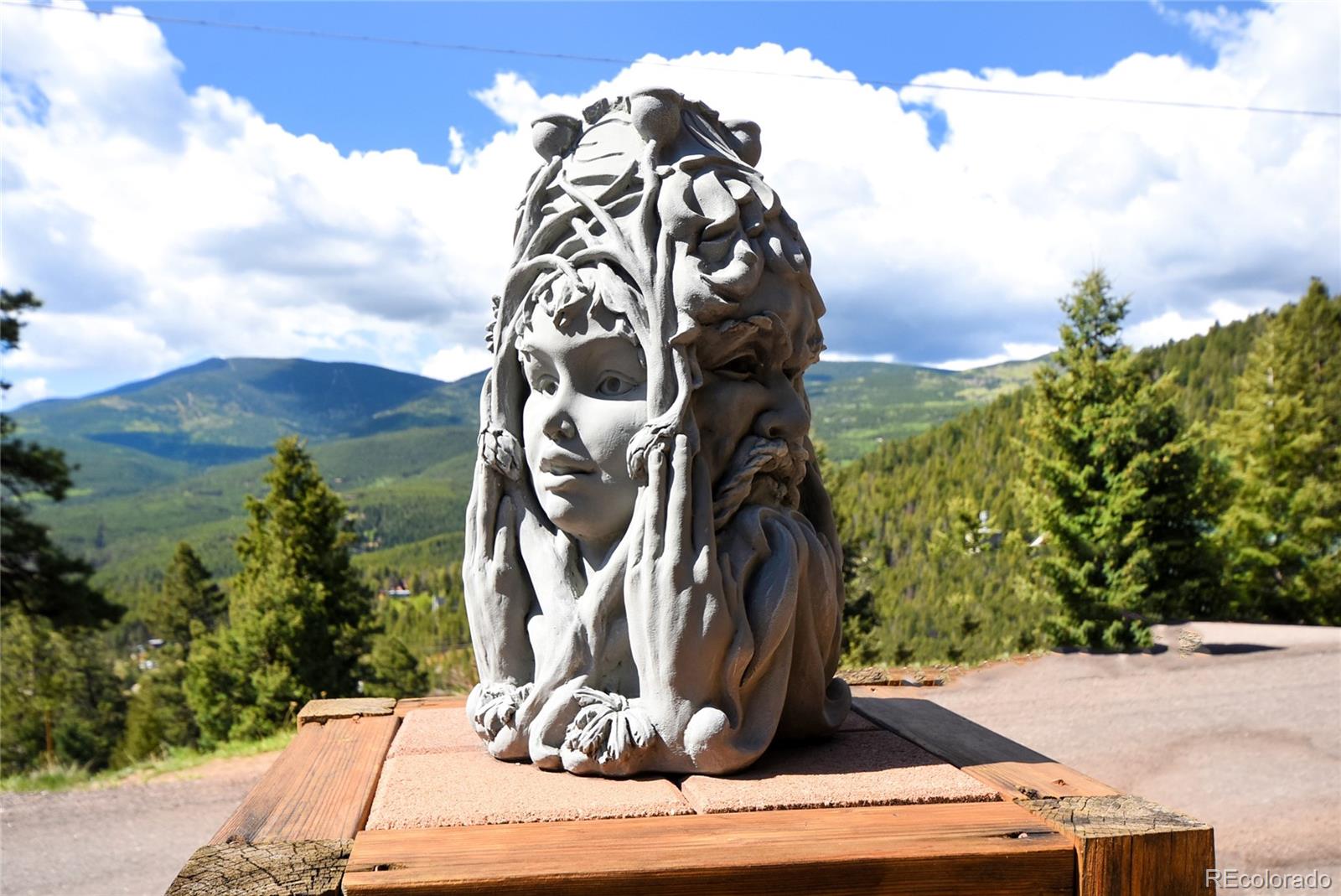 33633 Elk Run Evergreen, CO 80439 - Photo 36 of 40 a view of a wooden door and a bench