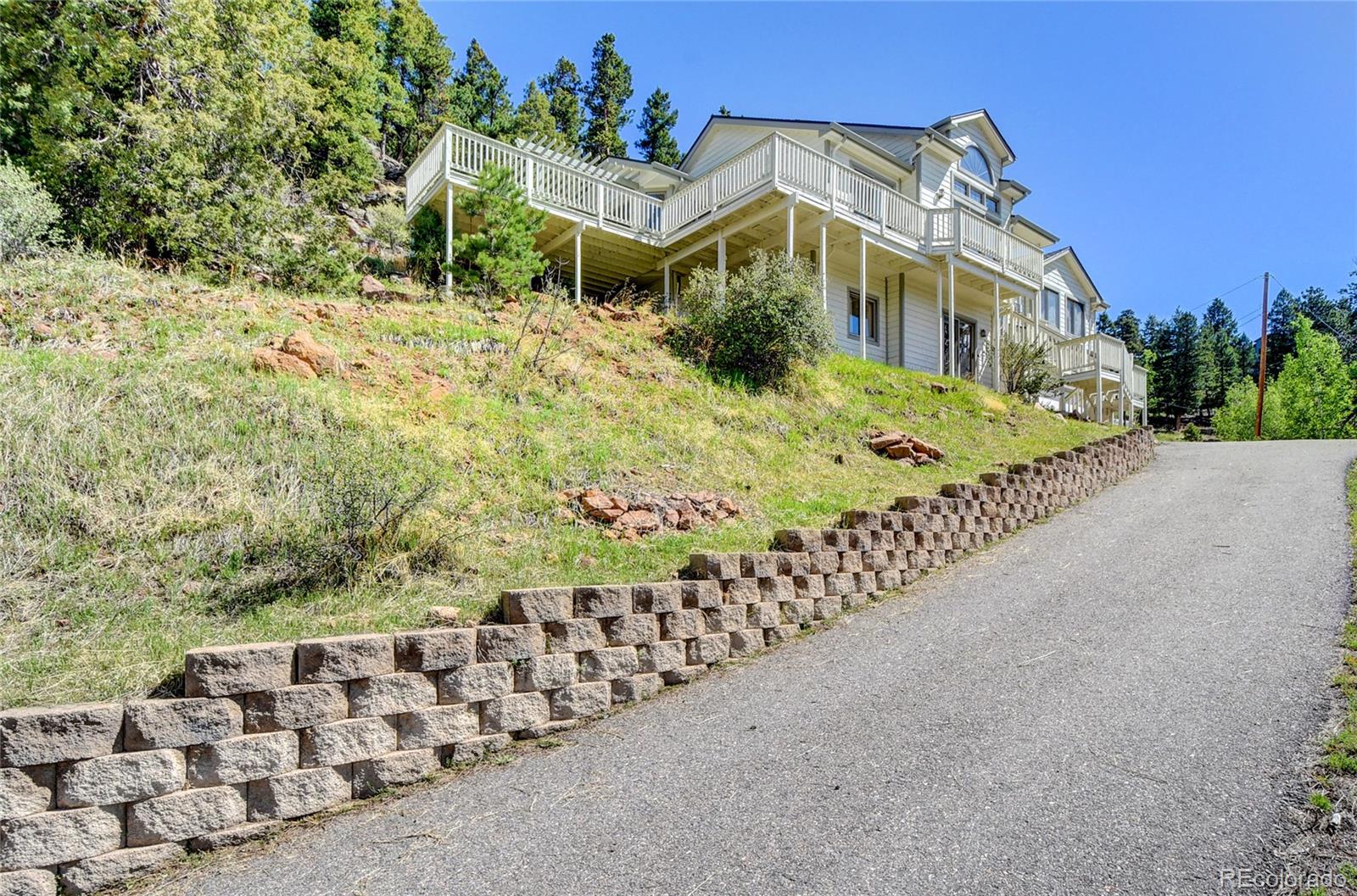33633 Elk Run Evergreen, CO 80439 - Photo 5 of 40 a view of a house with a yard and plant