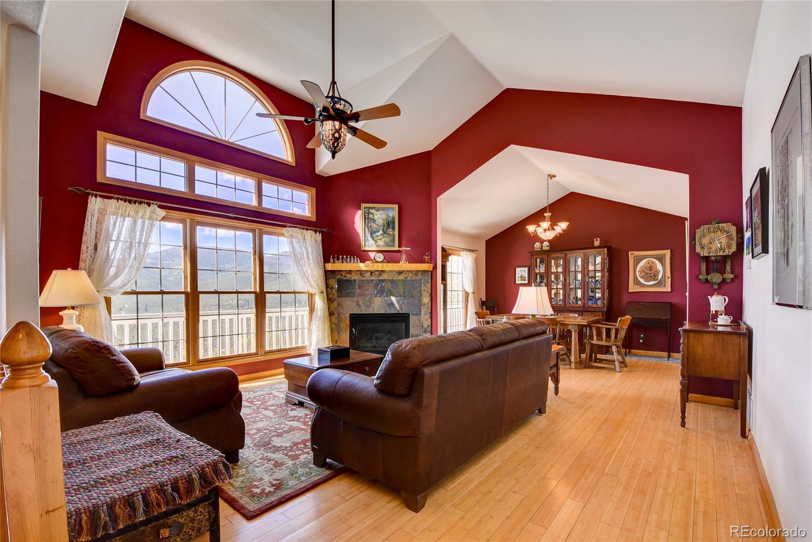 33633 Elk Run Evergreen, CO 80439 - Photo 7 of 40 a living room with furniture a fireplace and a ceiling fan