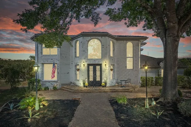 a front view of a house with a garden