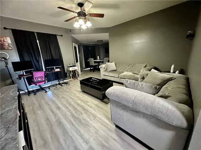 a living room with furniture a flat screen tv and a couch