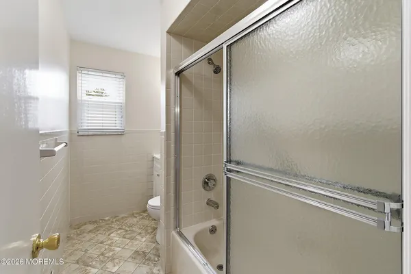 a bathroom with a shower and a toilet