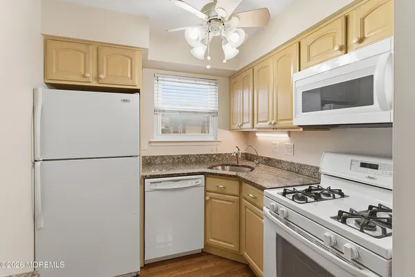a kitchen with stainless steel appliances white cabinets and a stove top oven