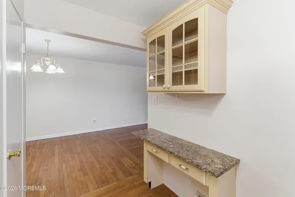 an empty room with wooden floor and a window
