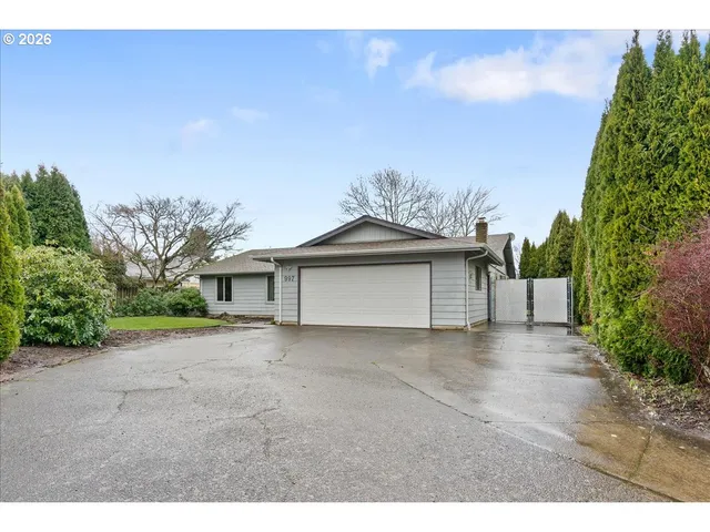 a view of a house with a yard and garage