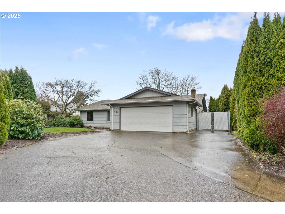 a view of a house with a yard and garage