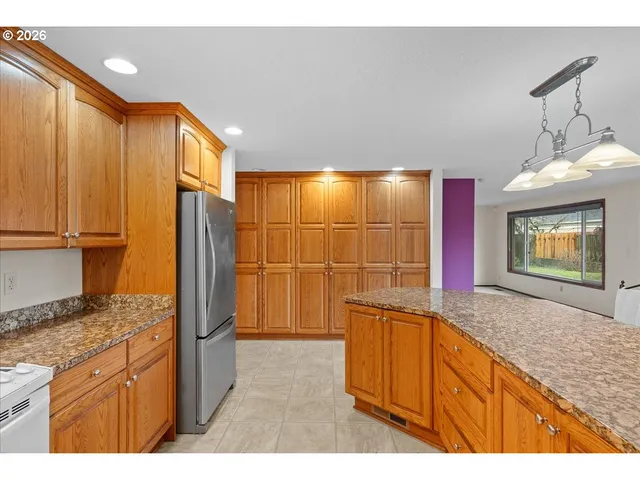 a bathroom with a sink a granite counter and a shower