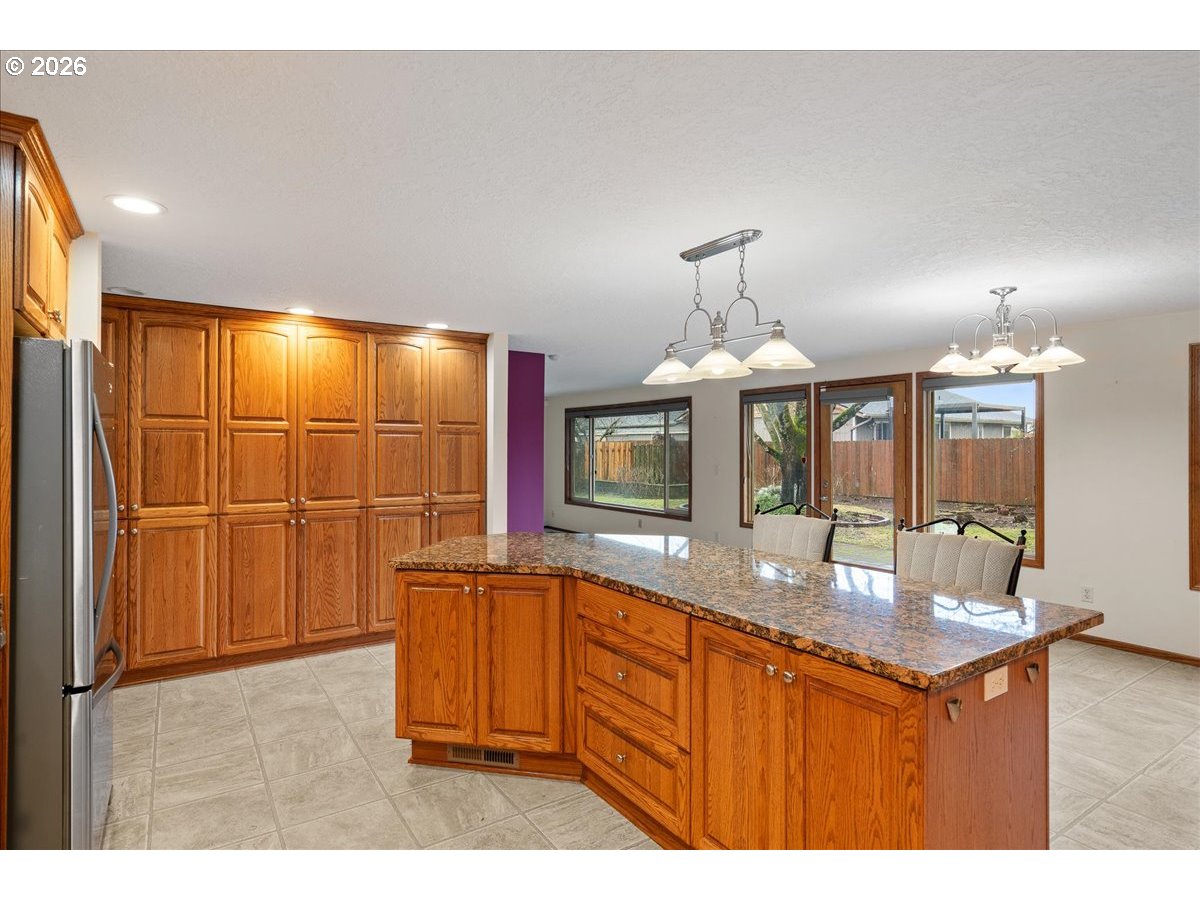997 Julie Street North Keizer, OR 97303 - Photo 13 of 30 a kitchen with stainless steel appliances granite countertop a sink and a granite counter tops with white countertops