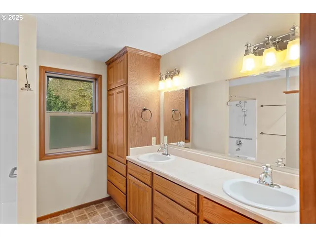 a bathroom with a granite countertop sink mirror and double