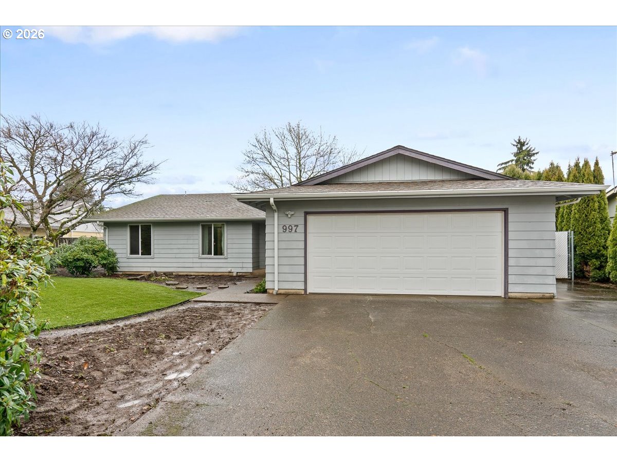 997 Julie Street North Keizer, OR 97303 - Photo 2 of 30 a front view of a house with a yard and garage