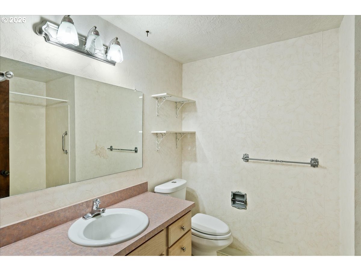 997 Julie Street North Keizer, OR 97303 - Photo 22 of 30 a bathroom with a sink toilet a mirror and shower