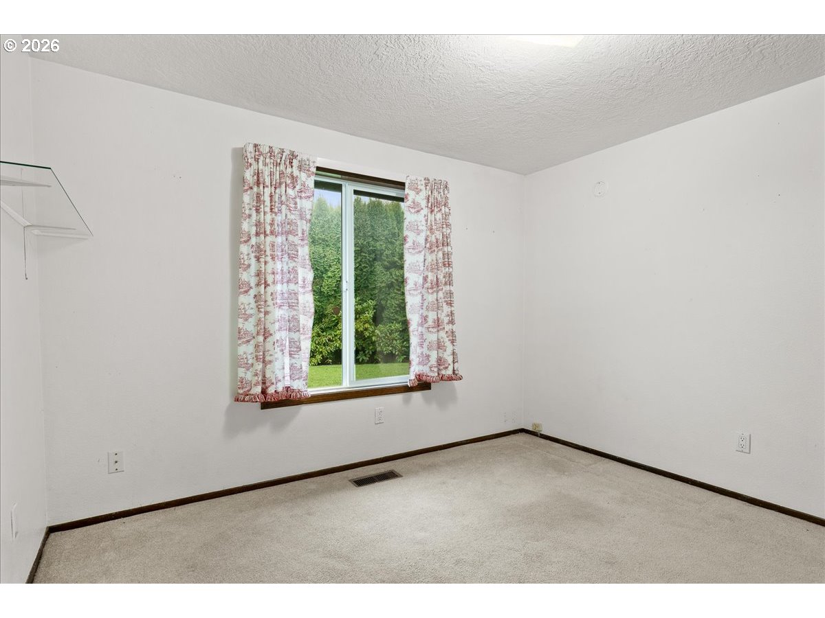 997 Julie Street North Keizer, OR 97303 - Photo 23 of 30 a view of an empty room with a window