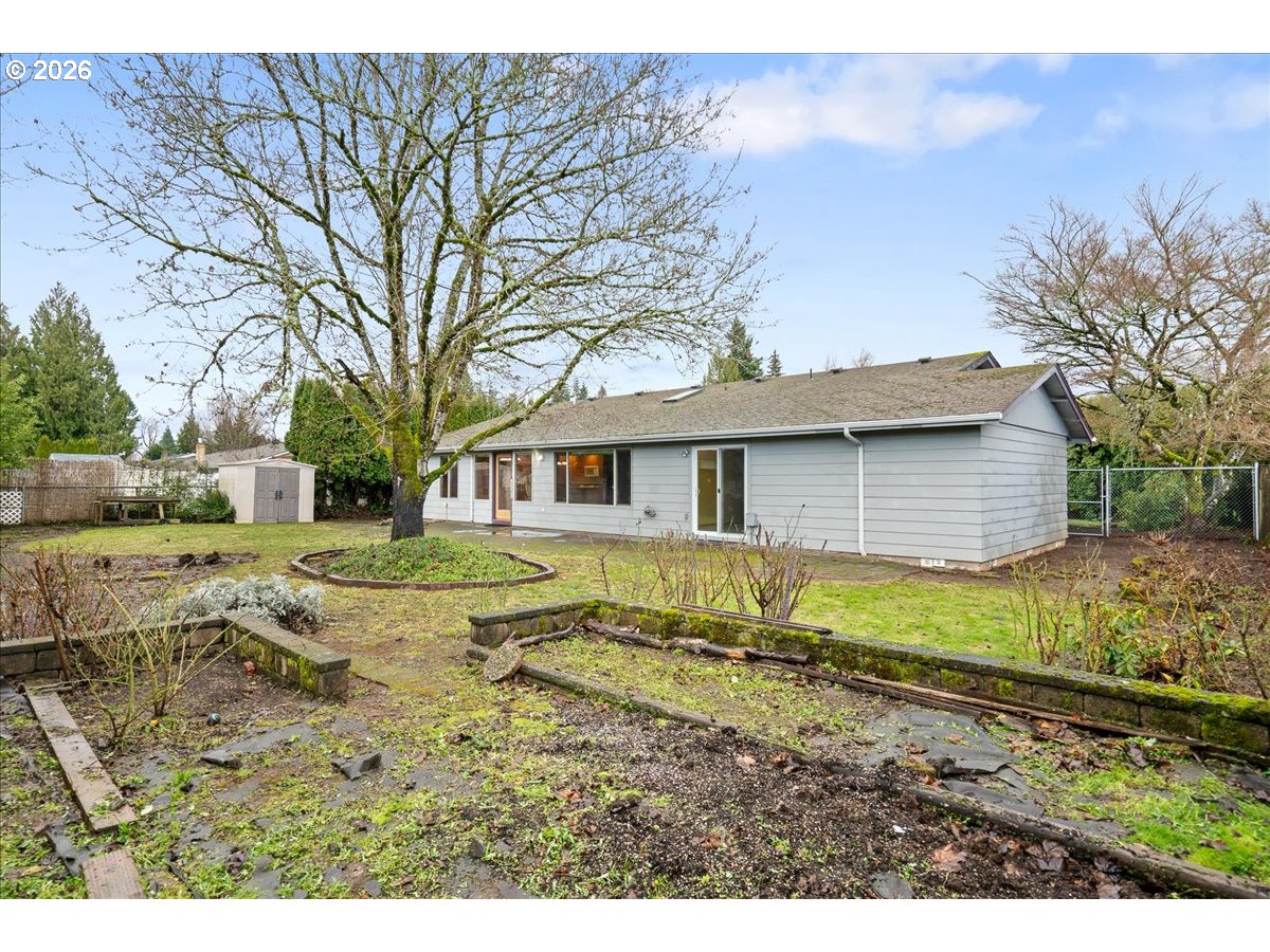 997 Julie Street North Keizer, OR 97303 - Photo 26 of 30 a view of a yard with a house with a large tree