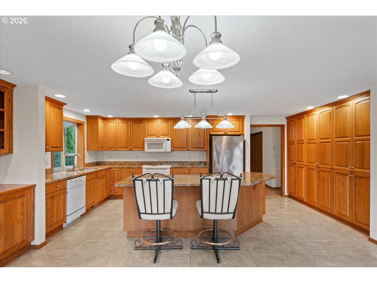997 Julie Street North Keizer, OR 97303 - Photo 10 of 30 a dining room with furniture wooden floor and chandelier