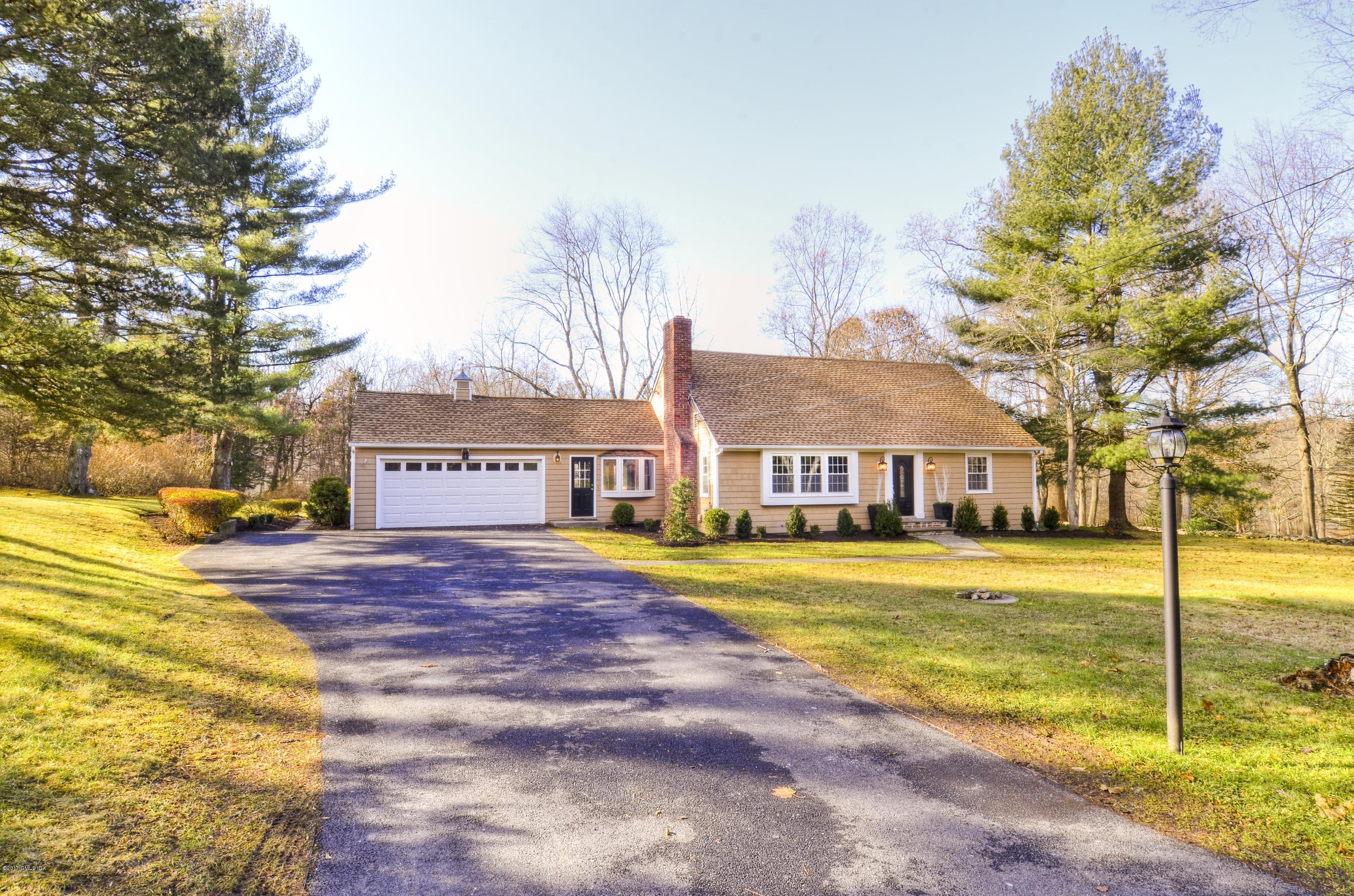 49 Ritch Drive Ridgefield, CT 06877 - Photo 1 of 24 a view of a house with a big yard and large trees