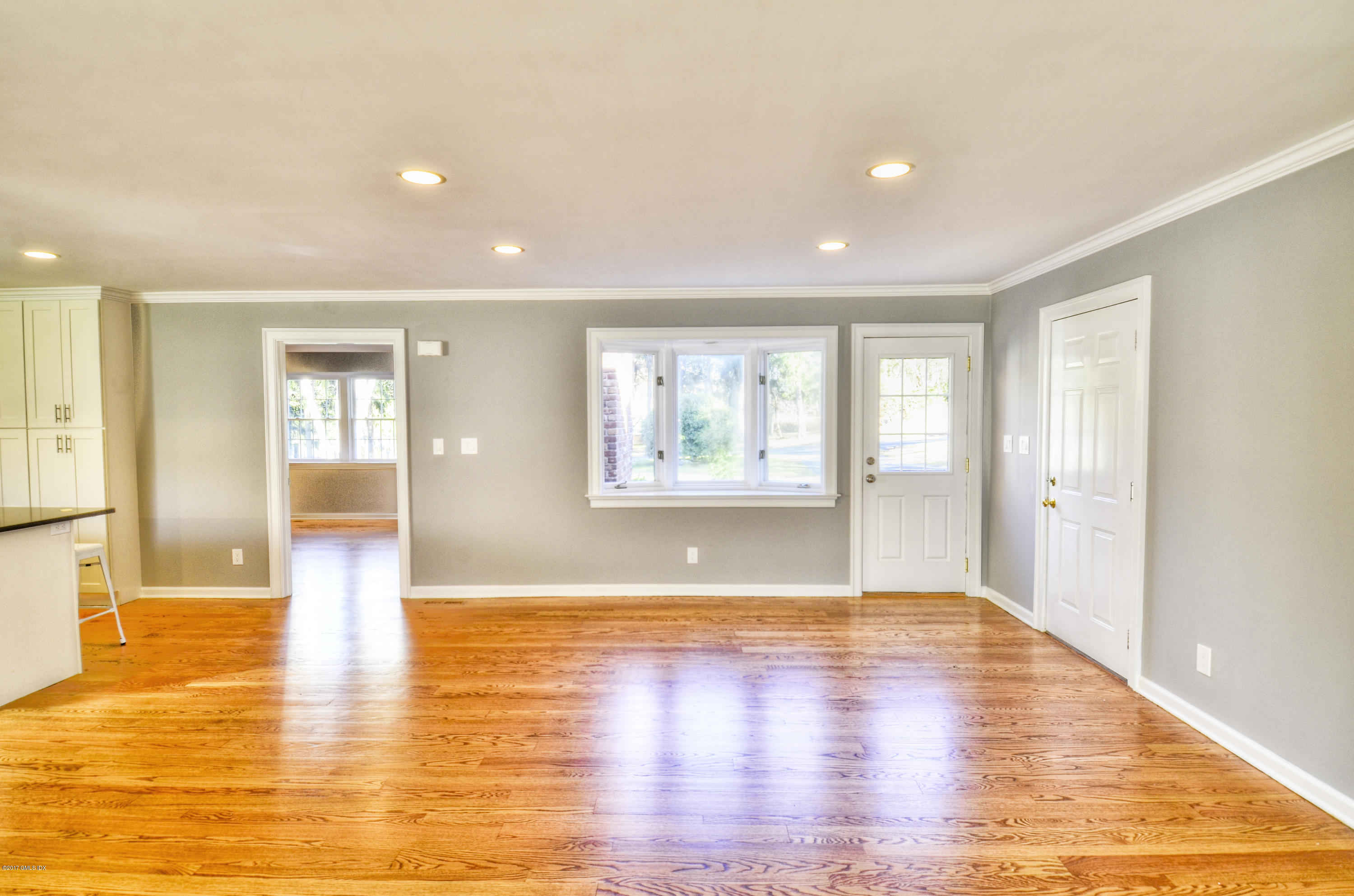 49 Ritch Drive Ridgefield, CT 06877 - Photo 11 of 24 a view of empty room with wooden floor and windows
