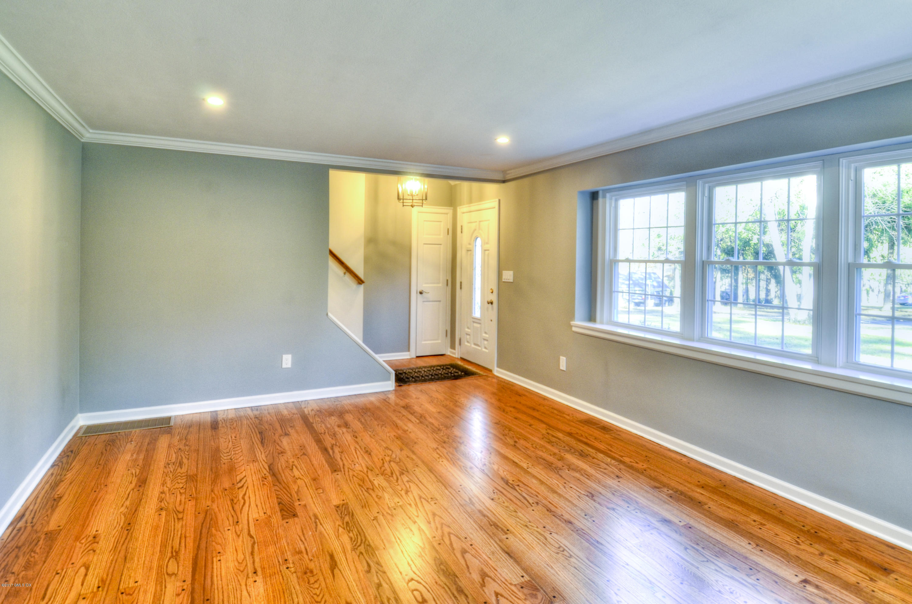 49 Ritch Drive Ridgefield, CT 06877 - Photo 13 of 24 a view of an empty room with wooden floor and a window