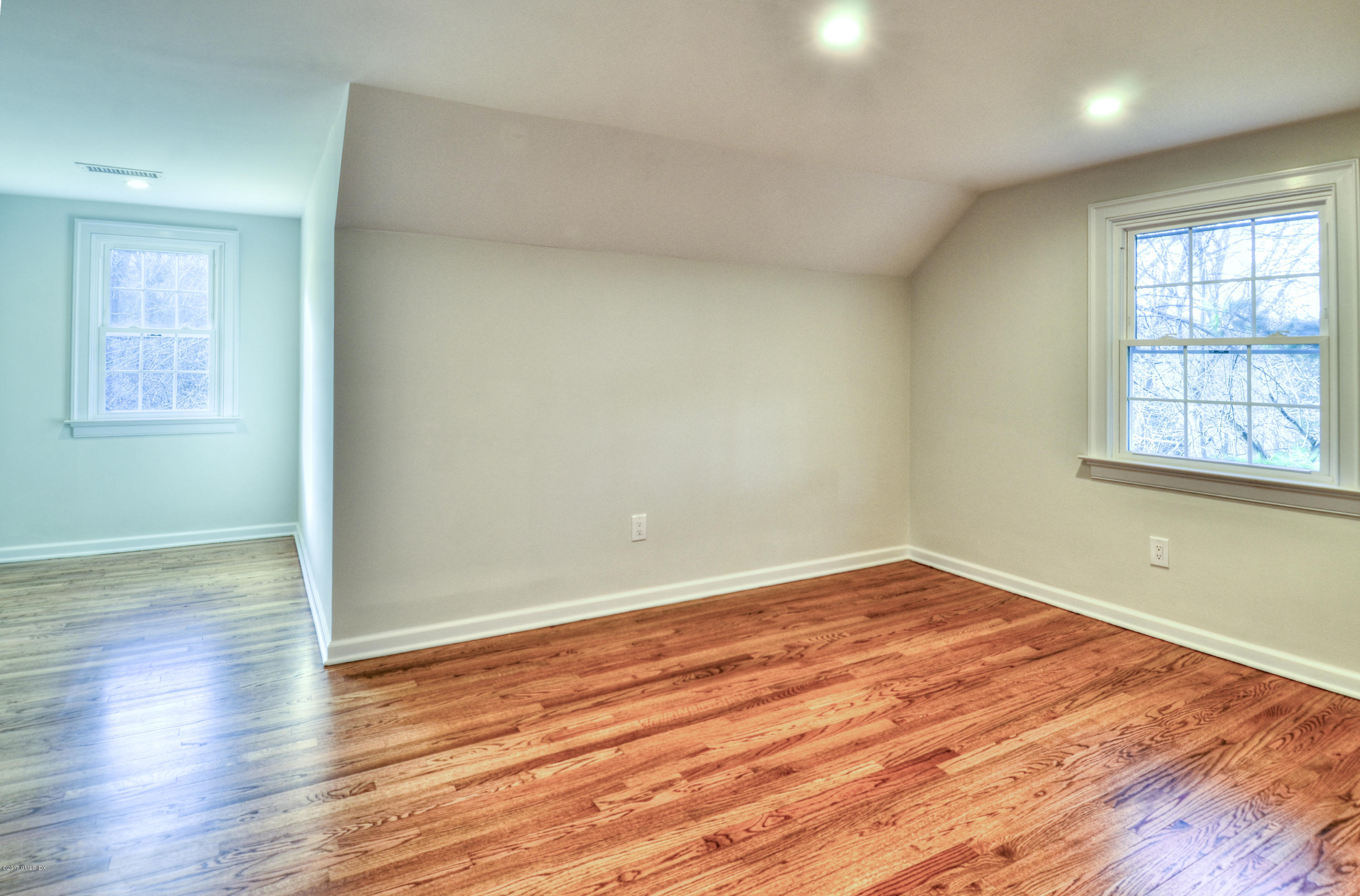 49 Ritch Drive Ridgefield, CT 06877 - Photo 14 of 24 an empty room with wooden floor and windows