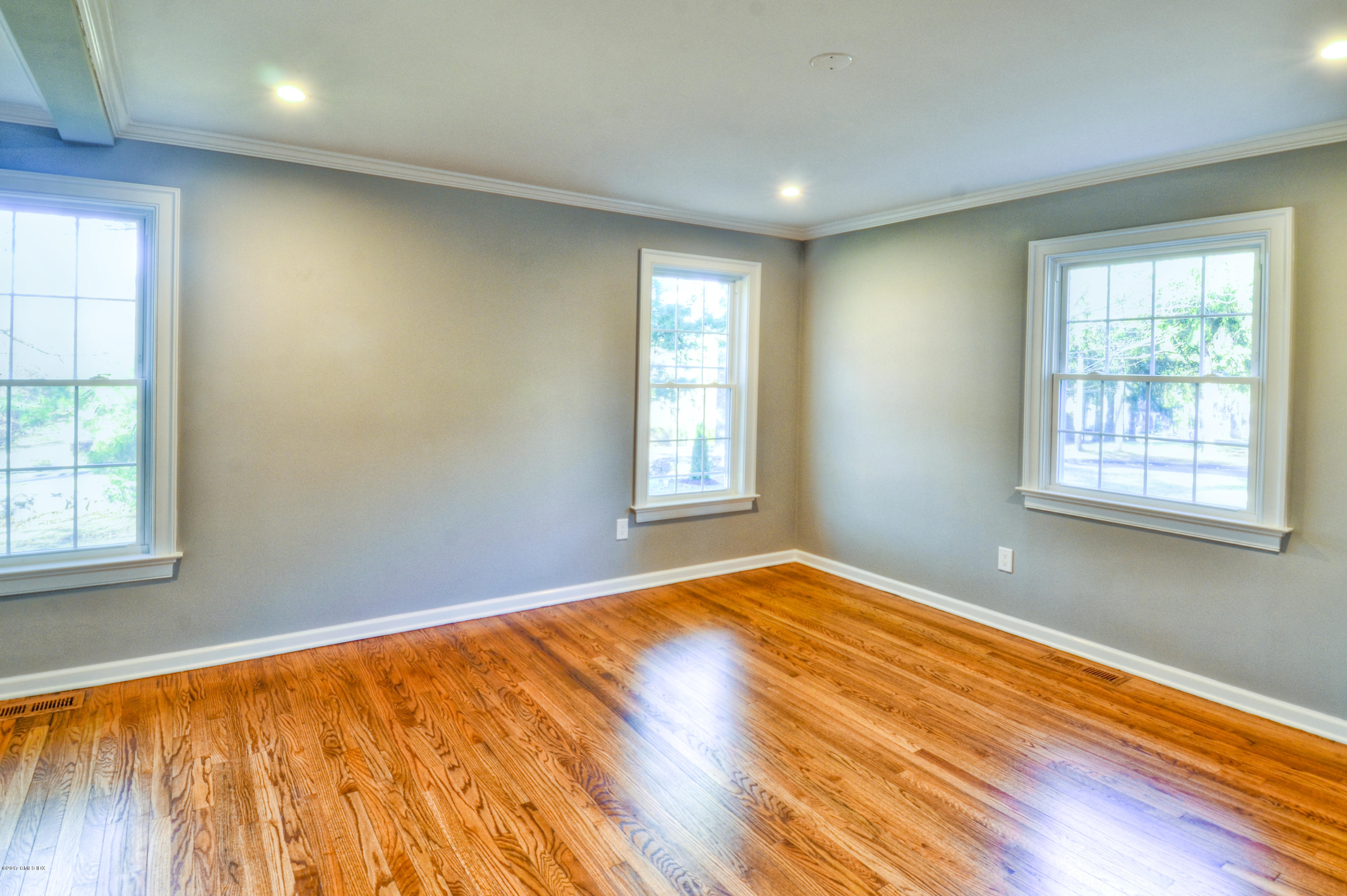 49 Ritch Drive Ridgefield, CT 06877 - Photo 16 of 24 a view of an empty room with wooden floor and a window