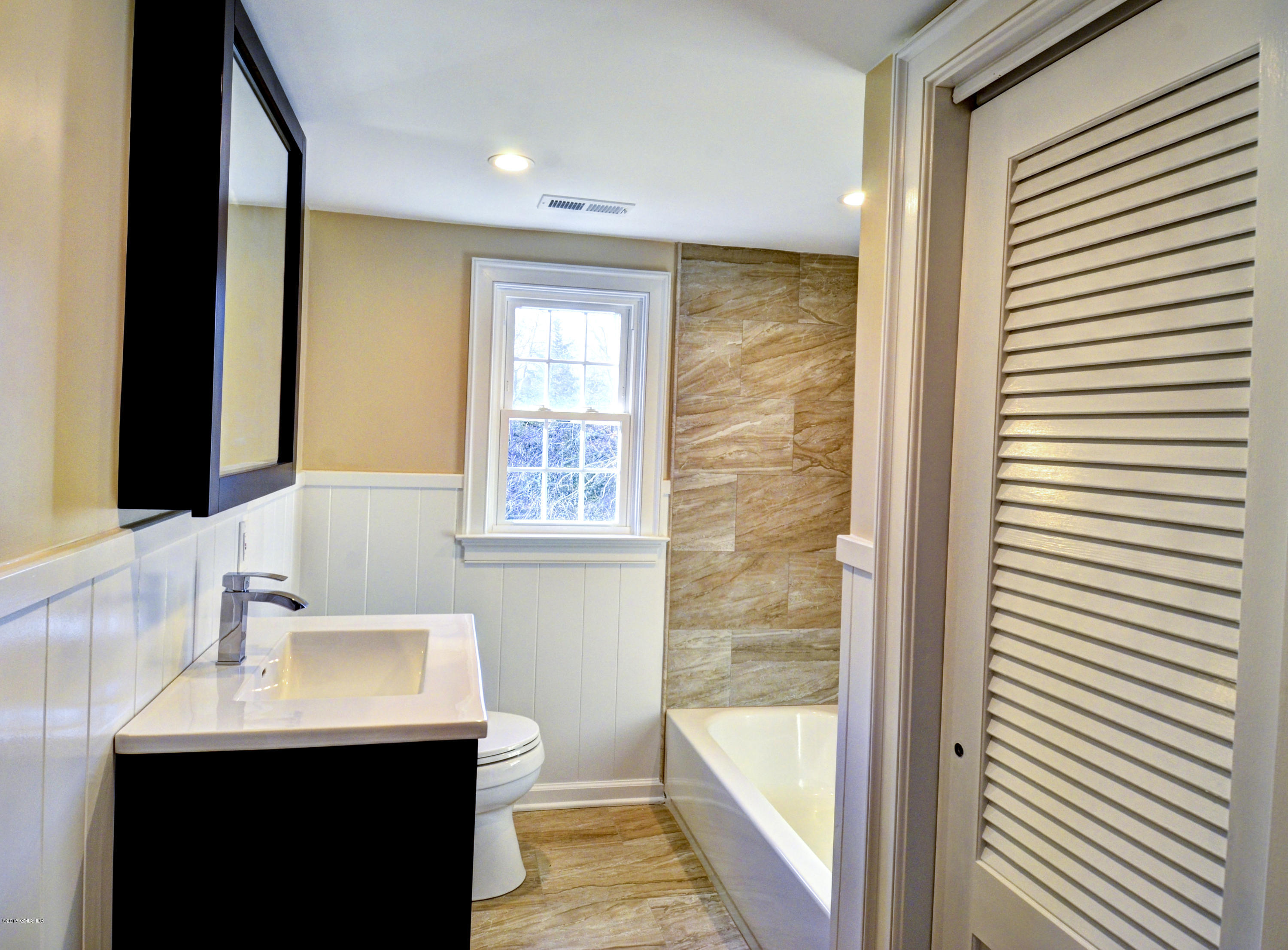 49 Ritch Drive Ridgefield, CT 06877 - Photo 20 of 24 a bathroom with a sink and a mirror