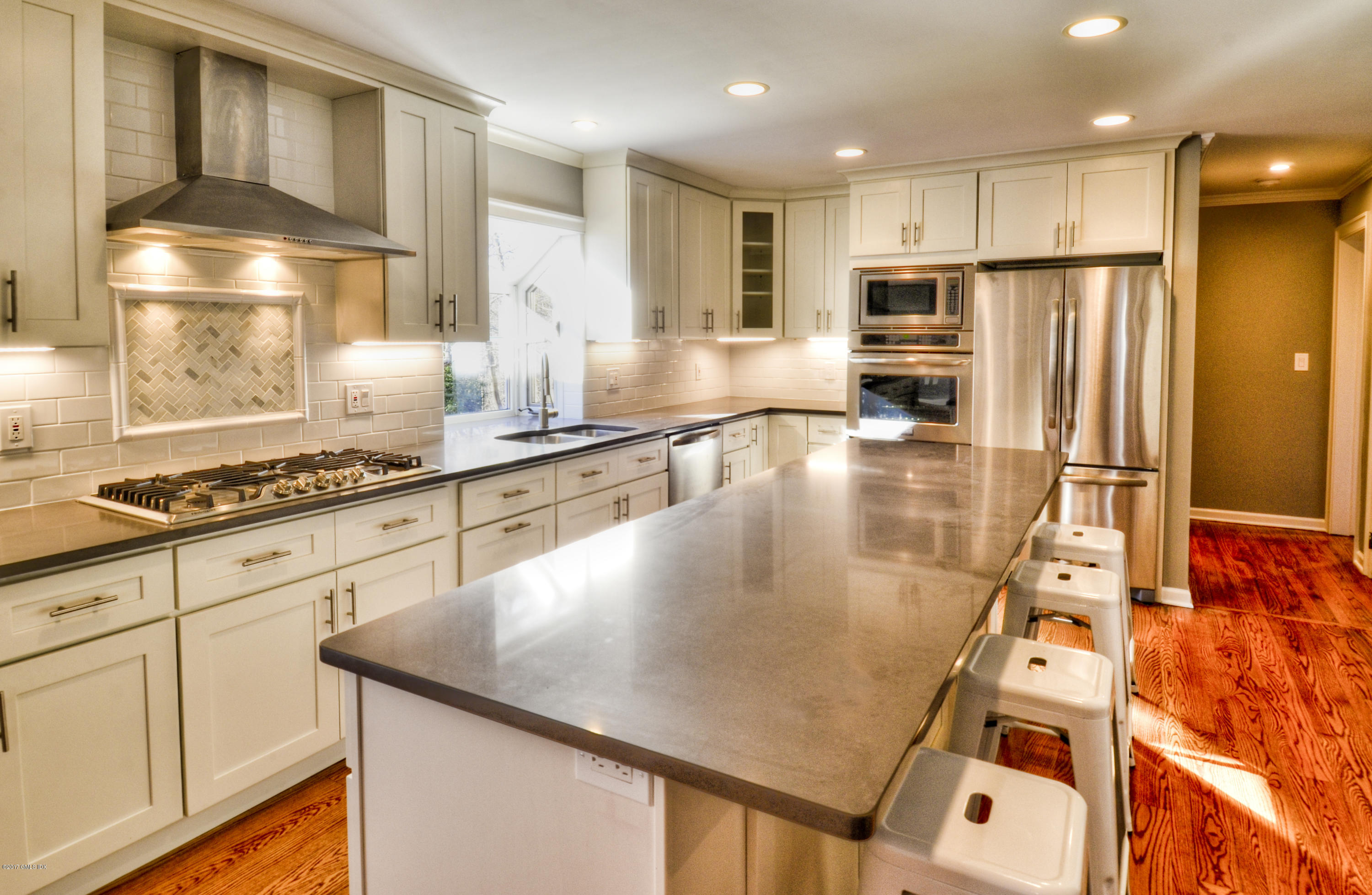 49 Ritch Drive Ridgefield, CT 06877 - Photo 2 of 24 a kitchen with stainless steel appliances granite countertop a sink a stove and a refrigerator