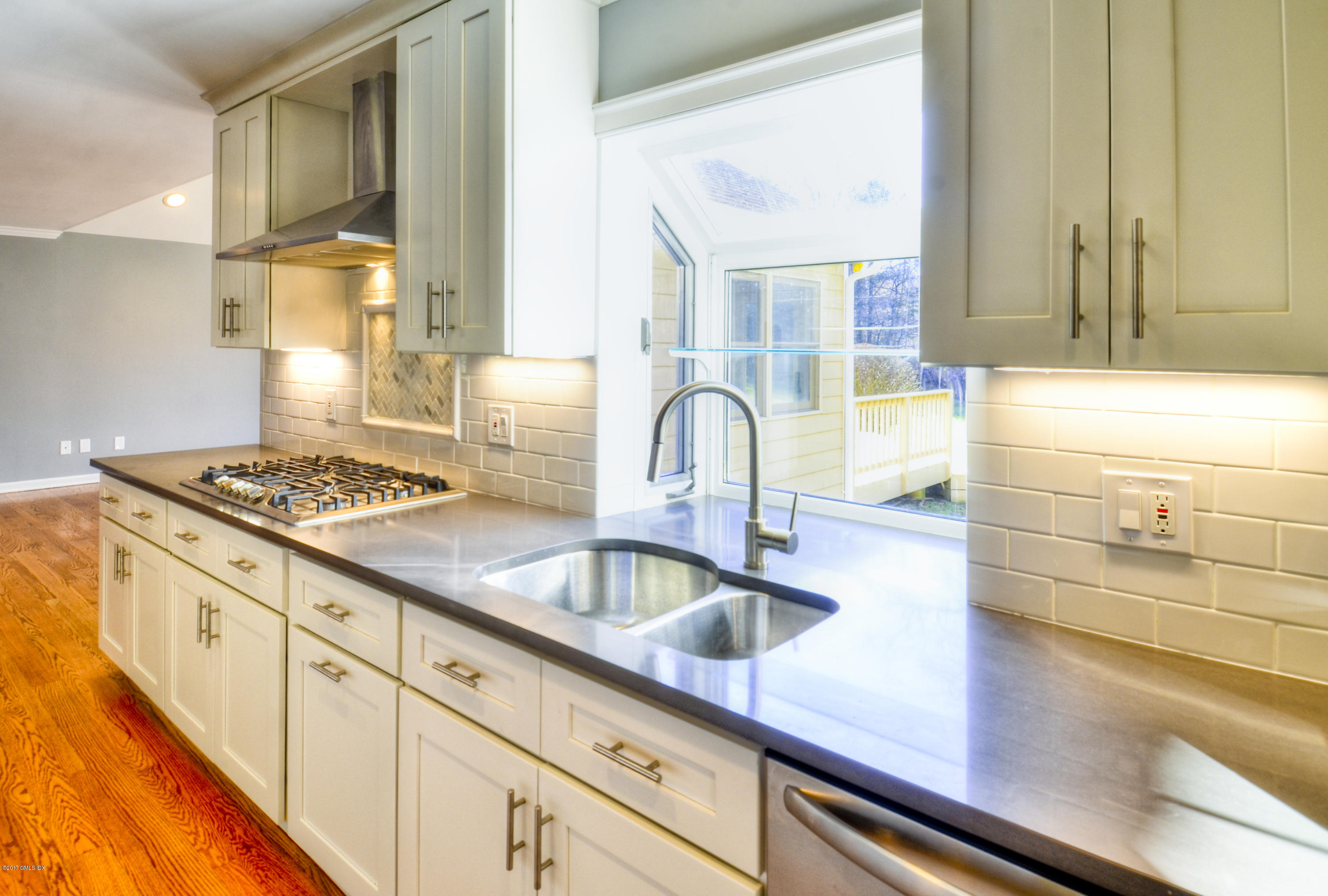 49 Ritch Drive Ridgefield, CT 06877 - Photo 4 of 24 a kitchen with sink a stove and cabinets