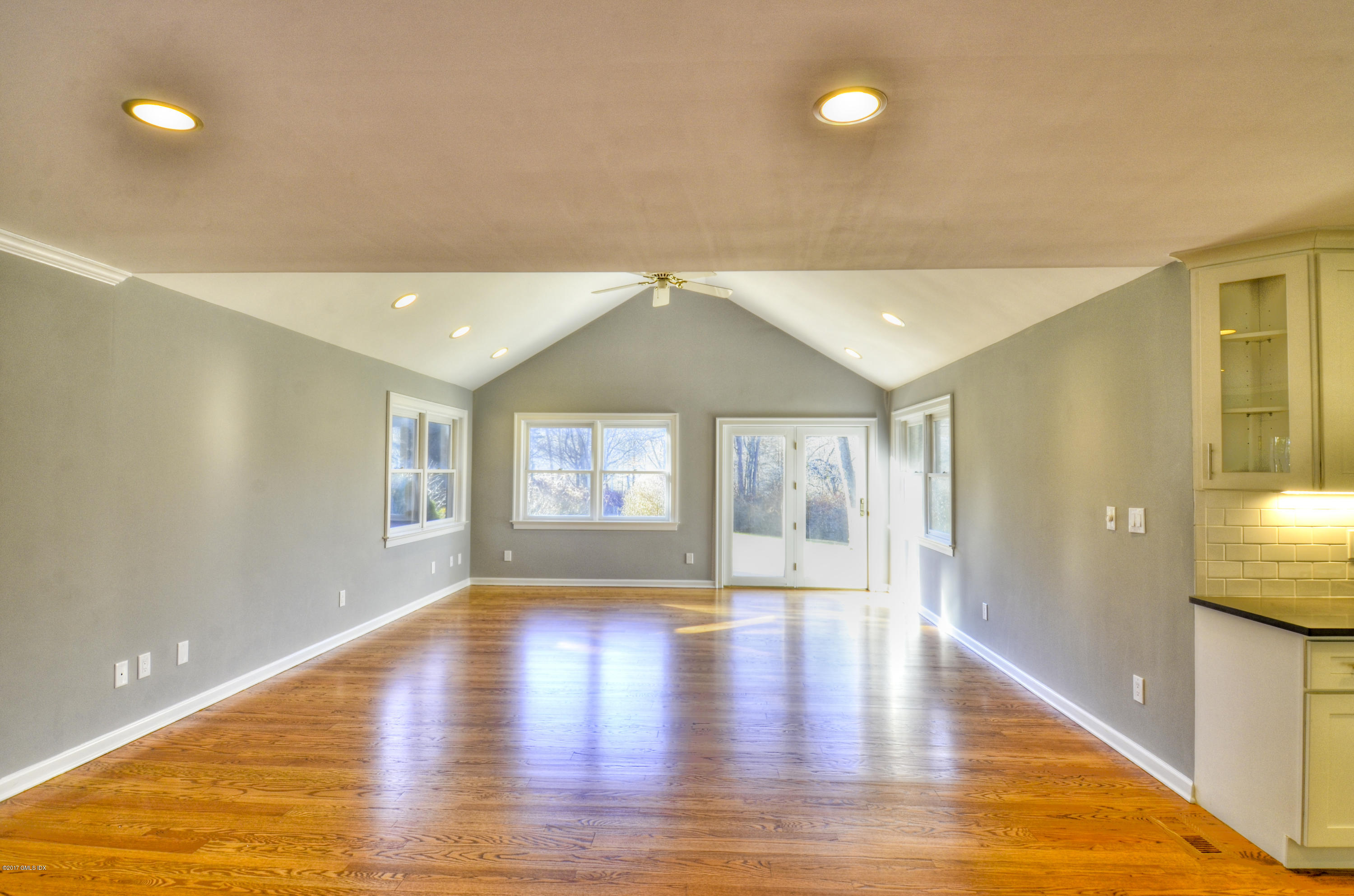 49 Ritch Drive Ridgefield, CT 06877 - Photo 10 of 24 a view of an empty room with window and wooden floor